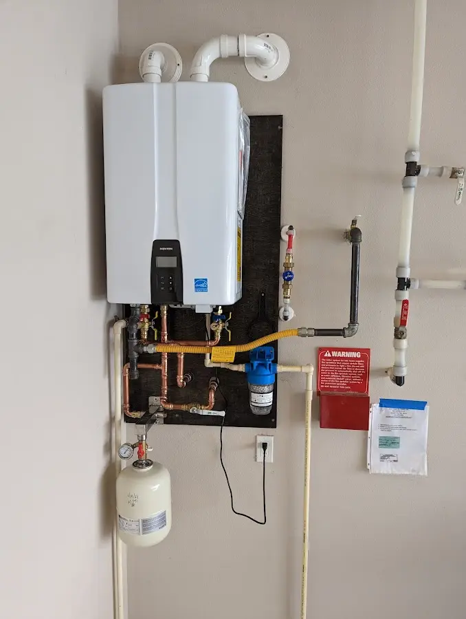 Professional plumber installing copper piping in a Columbia home